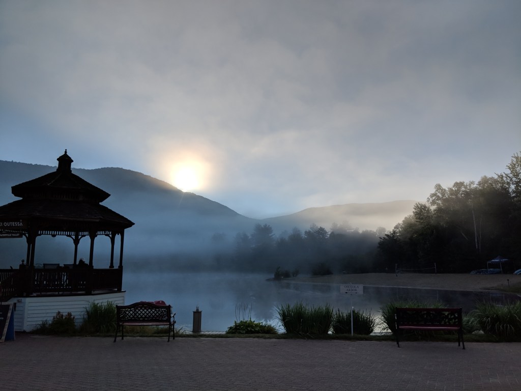 Mist rising from a lake early in the morning.